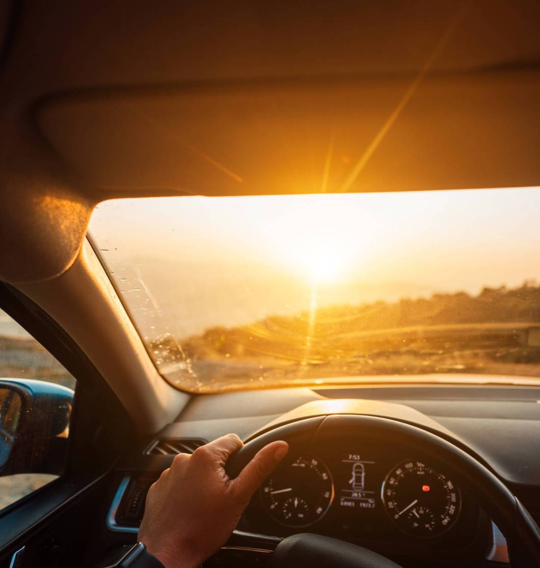 The road to success – a driver traveling on a road The road to success - a driver traveling on a road to the sun